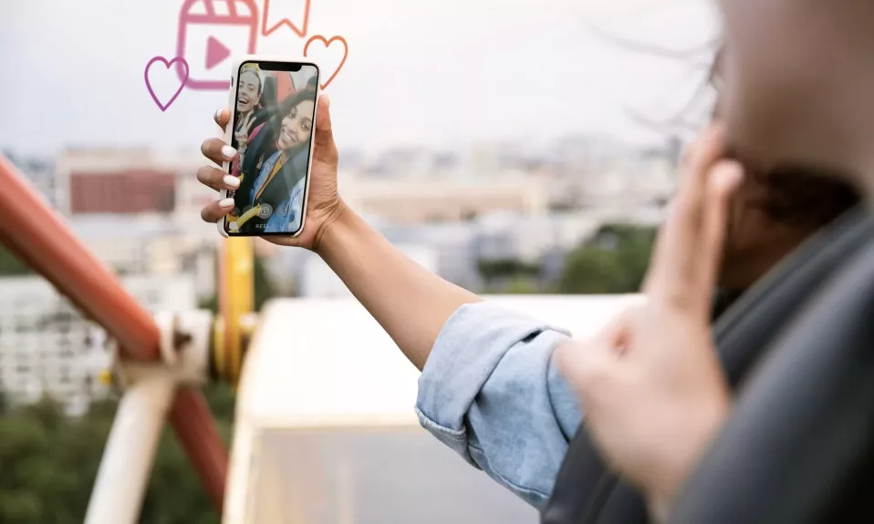 People taking a selfie on amusement ride.