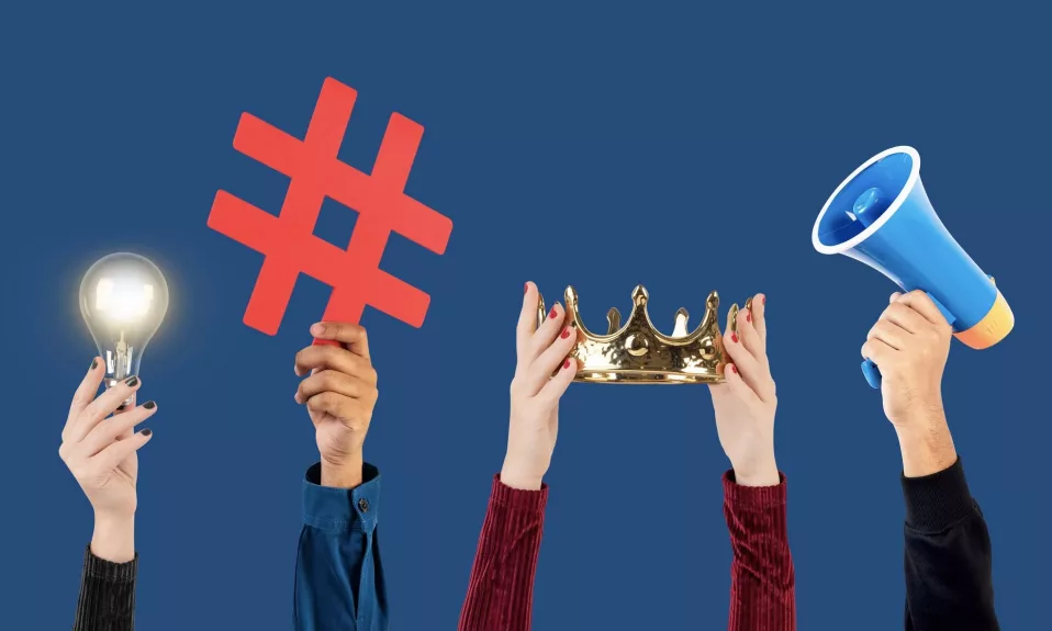 Hands holding hashtag, lightbulb, crown, and megaphone