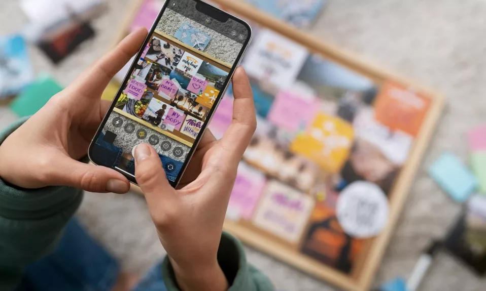 Person browsing vision board images on smartphone.