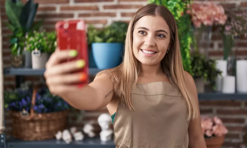 Woman taking a selfie in garden center.